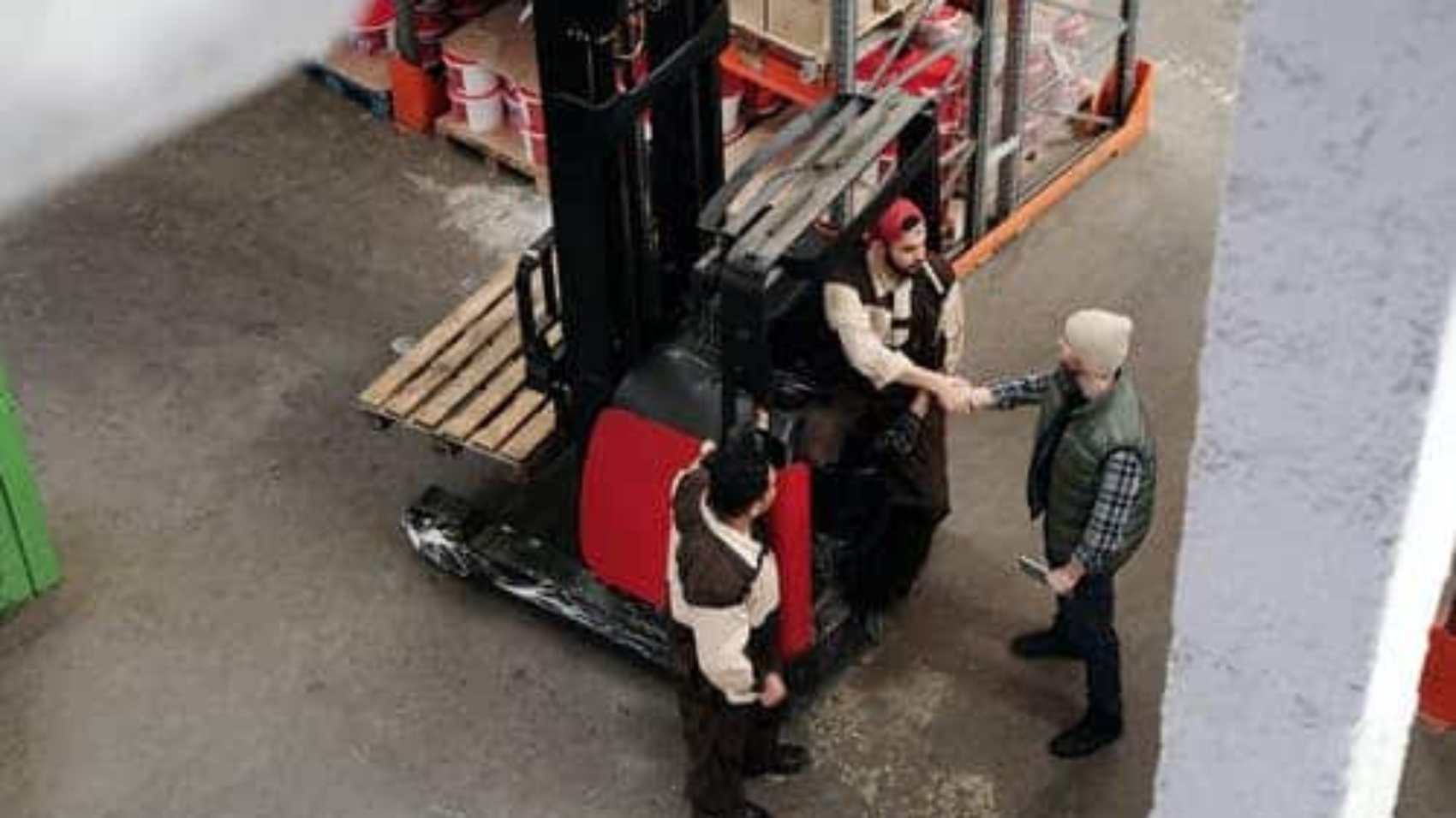 warehouse workers shaking hands and talking