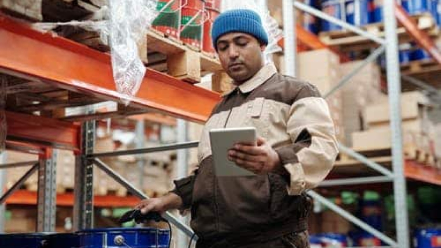 warehouse worker checking inventory with tablet