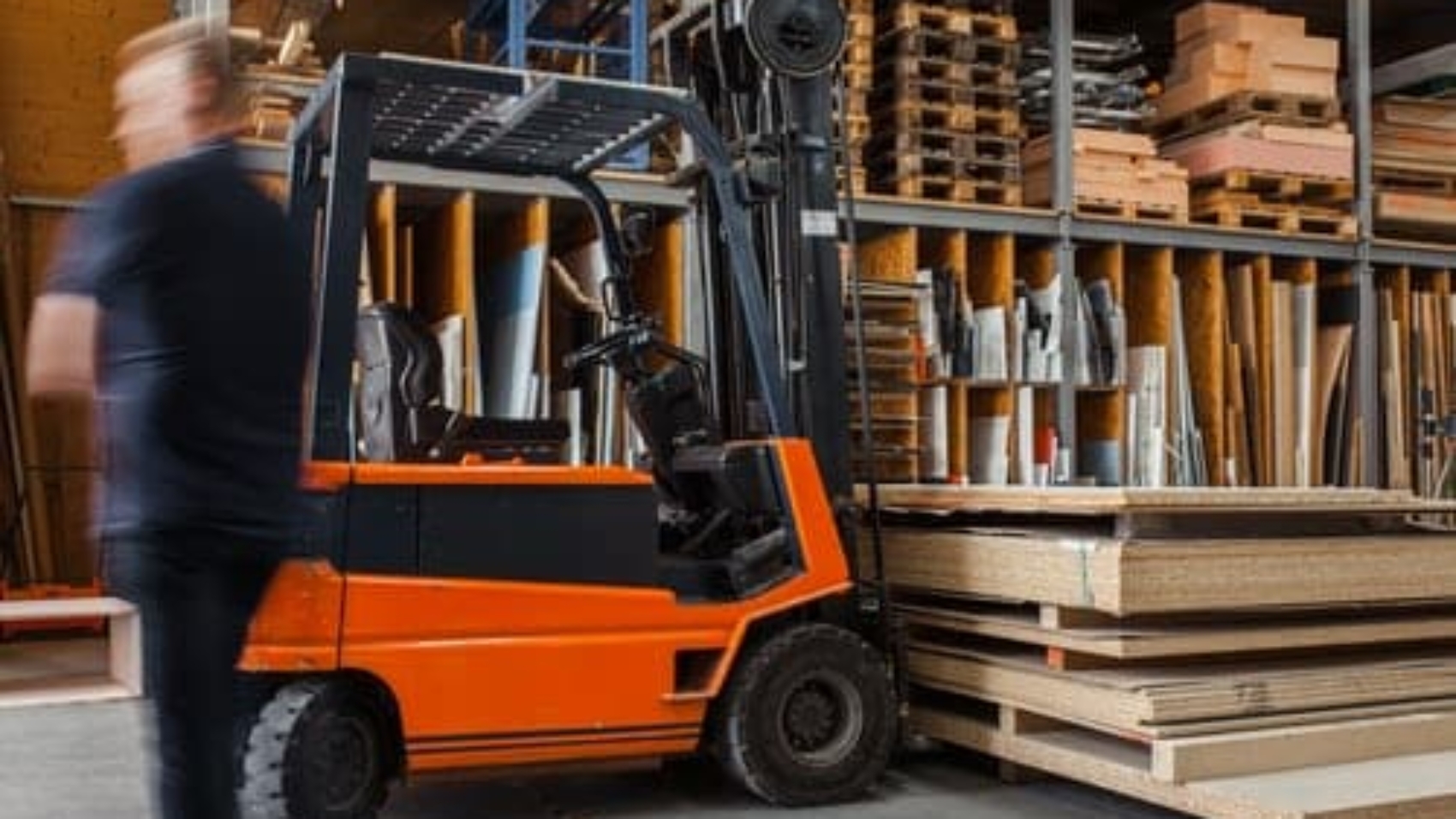 man walking away from forklift