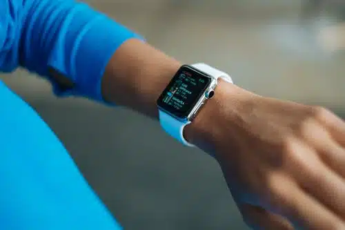 person looking at watch on their left wrist