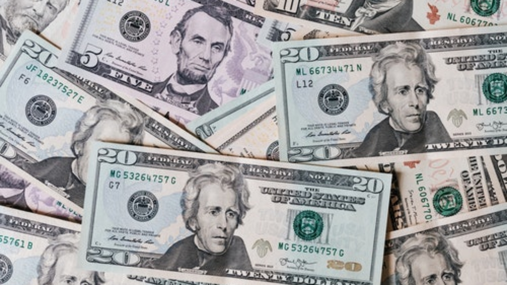 dollar bills layer over top each other