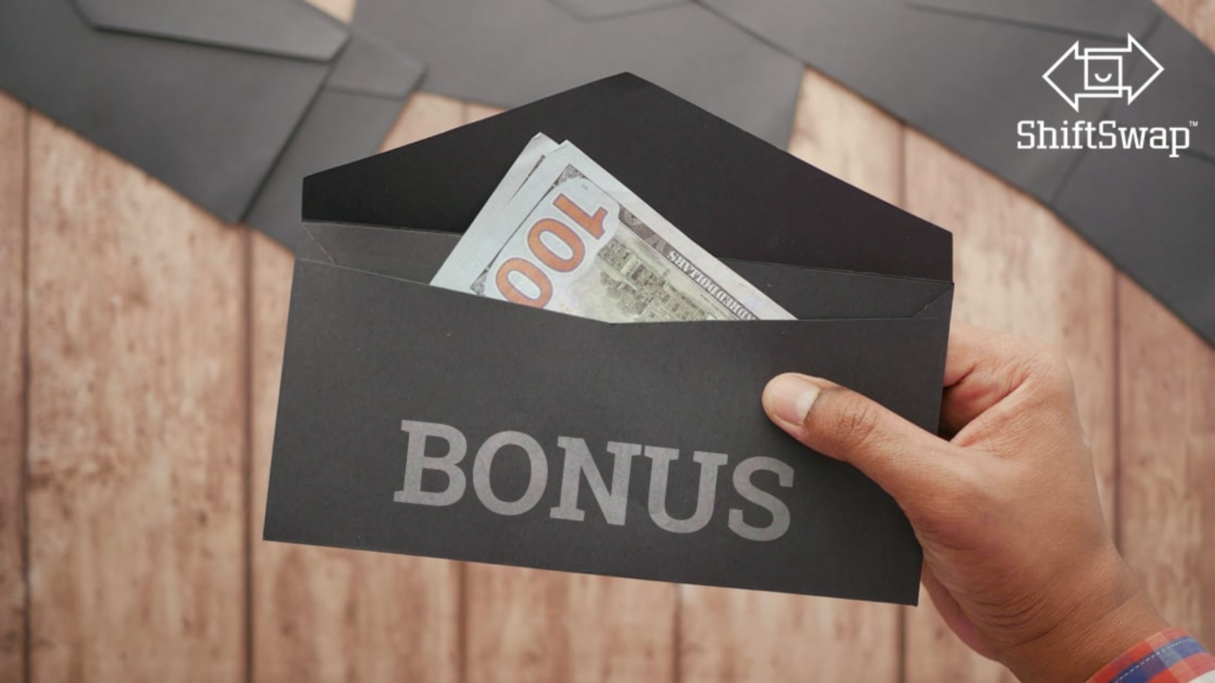 Image showing money in an envelope with "Bonus" written. Focused on the short term benefit not the long term impact of signing bonuses.
