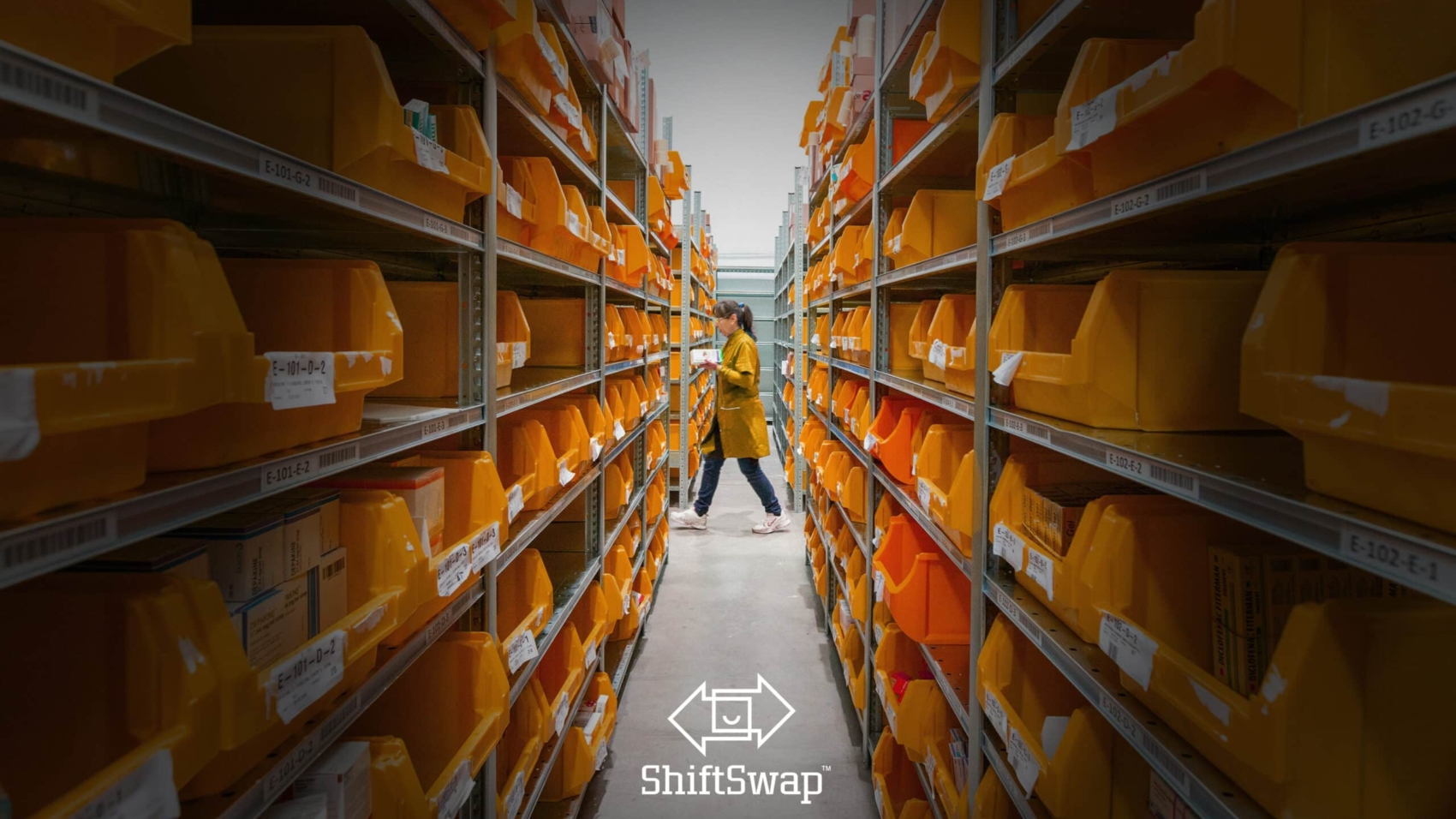 warehouse working walking past an aisle
