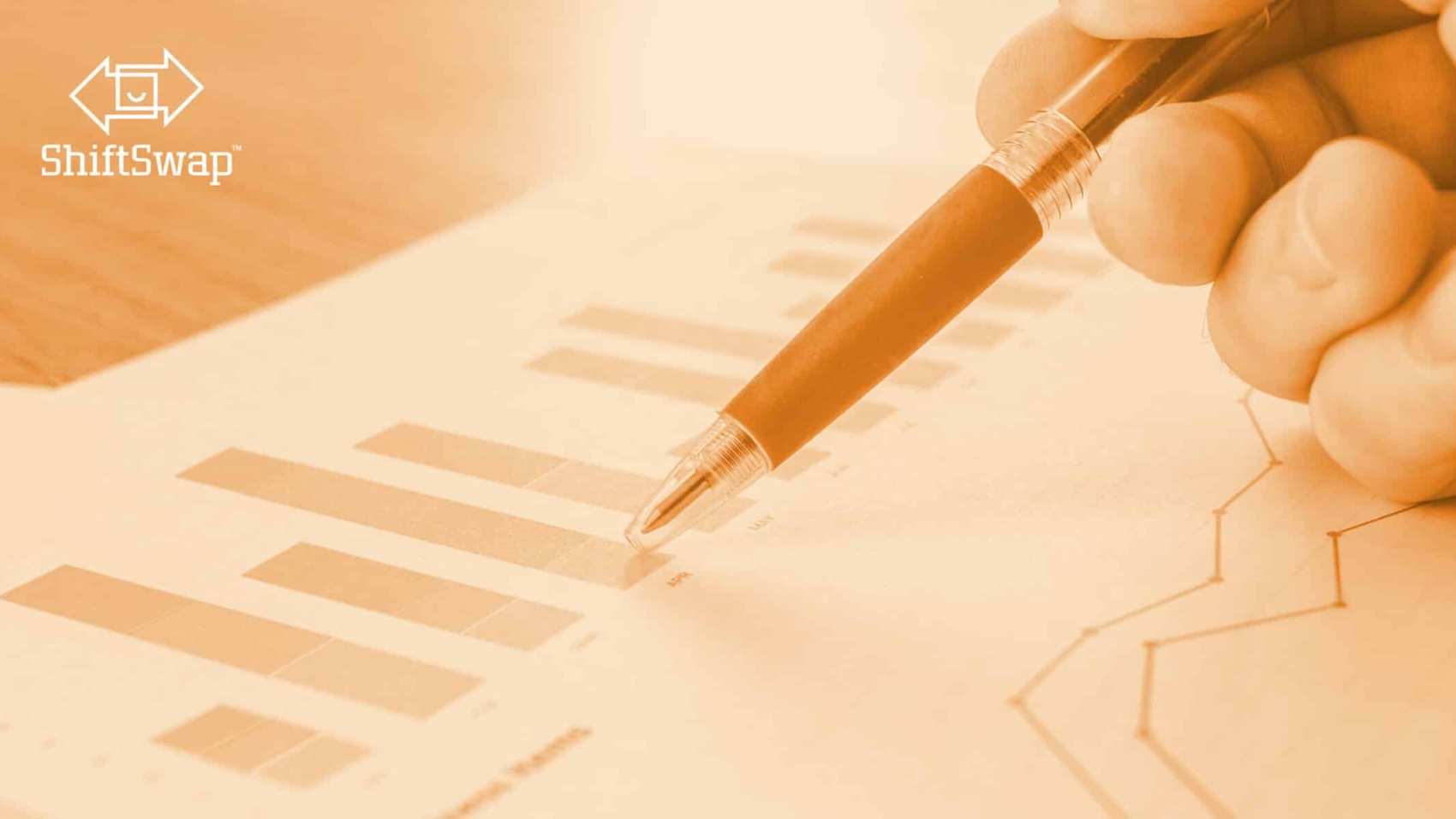 pen pointing at a graph showing data