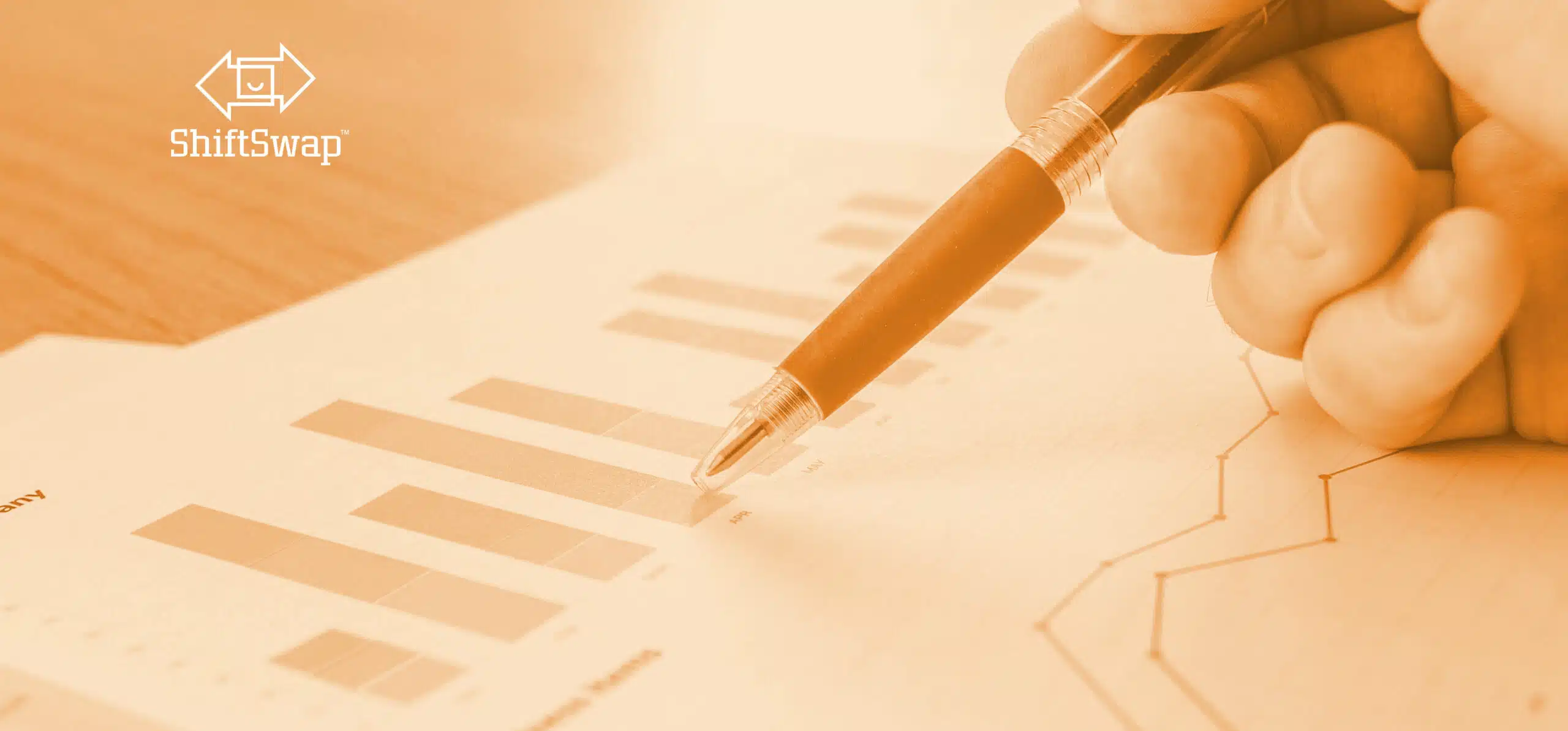 pen pointing at a graph showing data