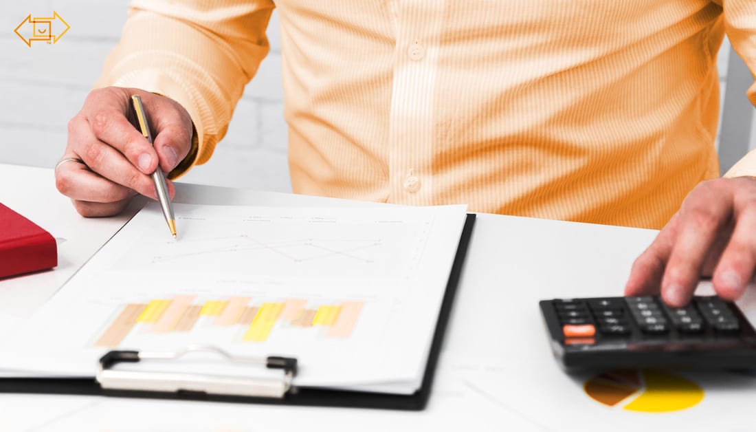male close up with graph and calculator on desk