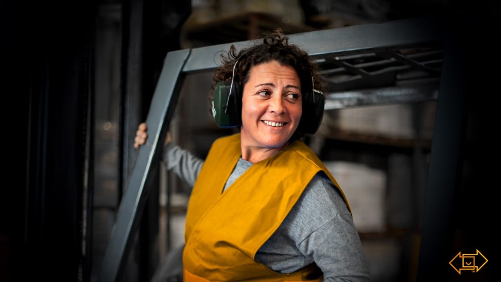 frontline worker smiling on forklift