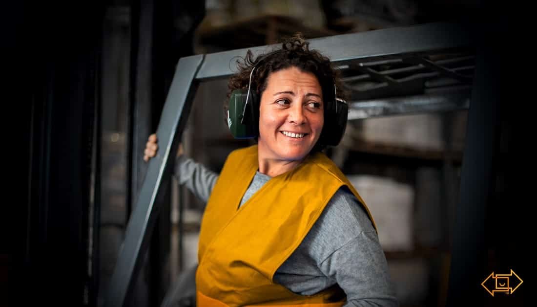 frontline worker smiling on forklift