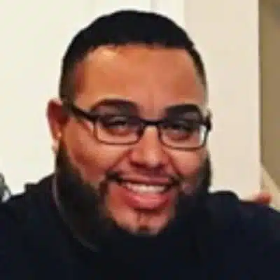 male with glass smiling