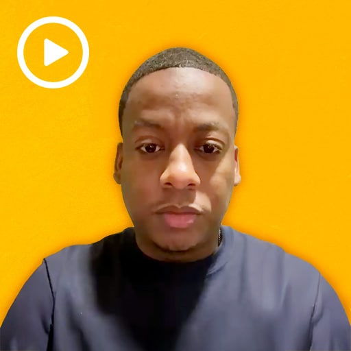 warehouse worker with a play button in the top left corner