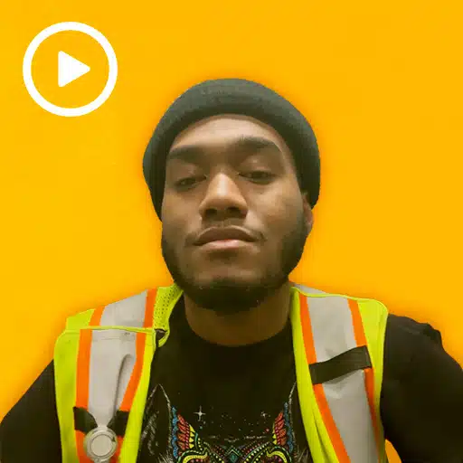 warehouse worker with a play button in the top left corner