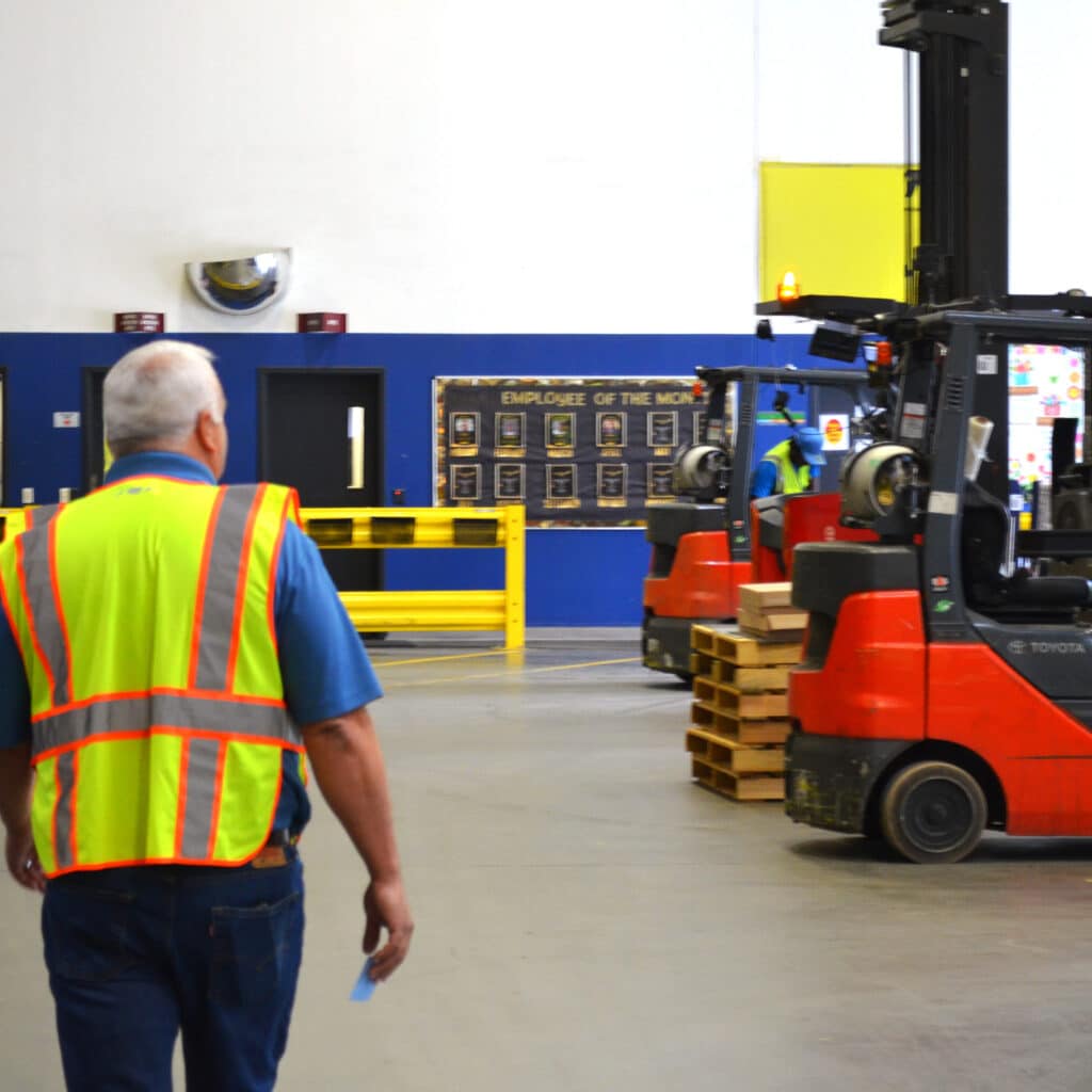 male warehouse general manager walking away in a warehouse