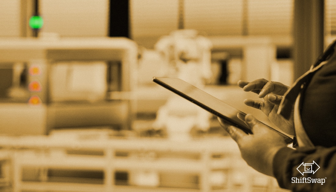 human holding tech, tablet, in a warehouse