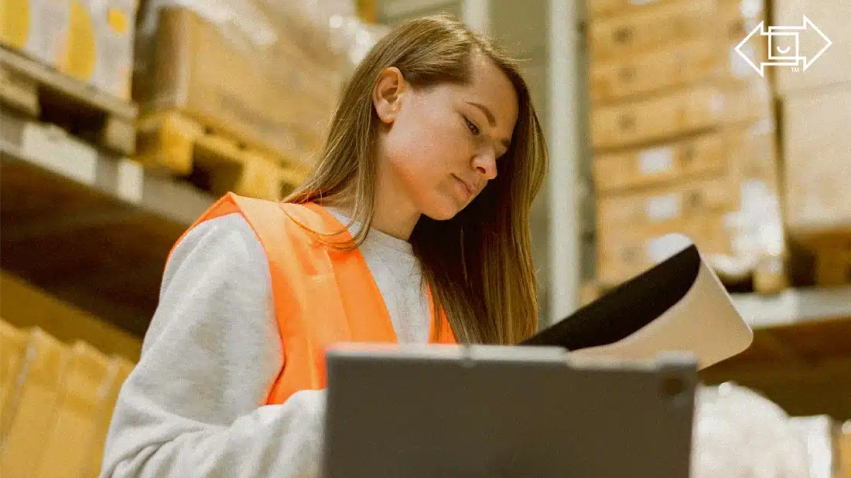 warehouse worker at a large enterprise looking at a clipboard
