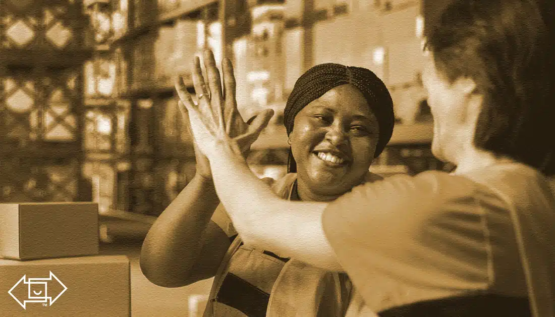female worker high-fiving a male employee showing good employee engagement