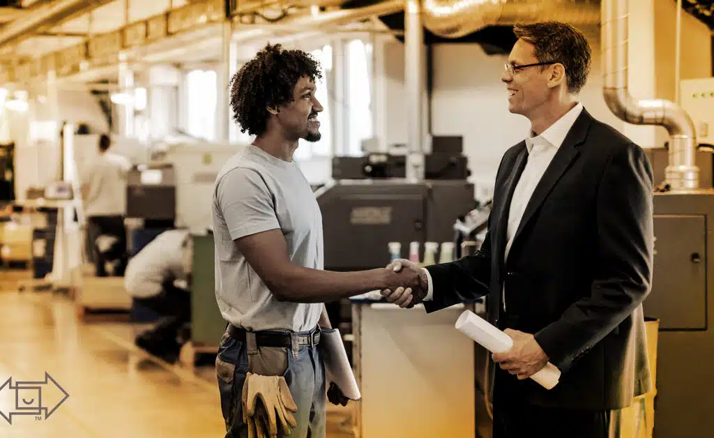 male coworker shaking hands with male supervisor