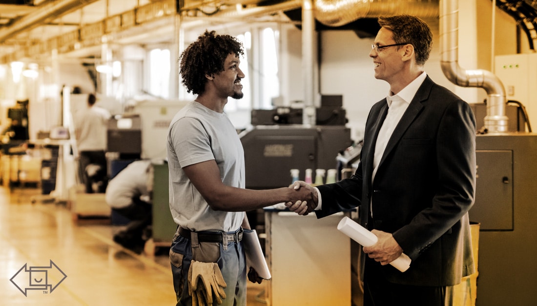 male coworker shaking hands with male supervisor