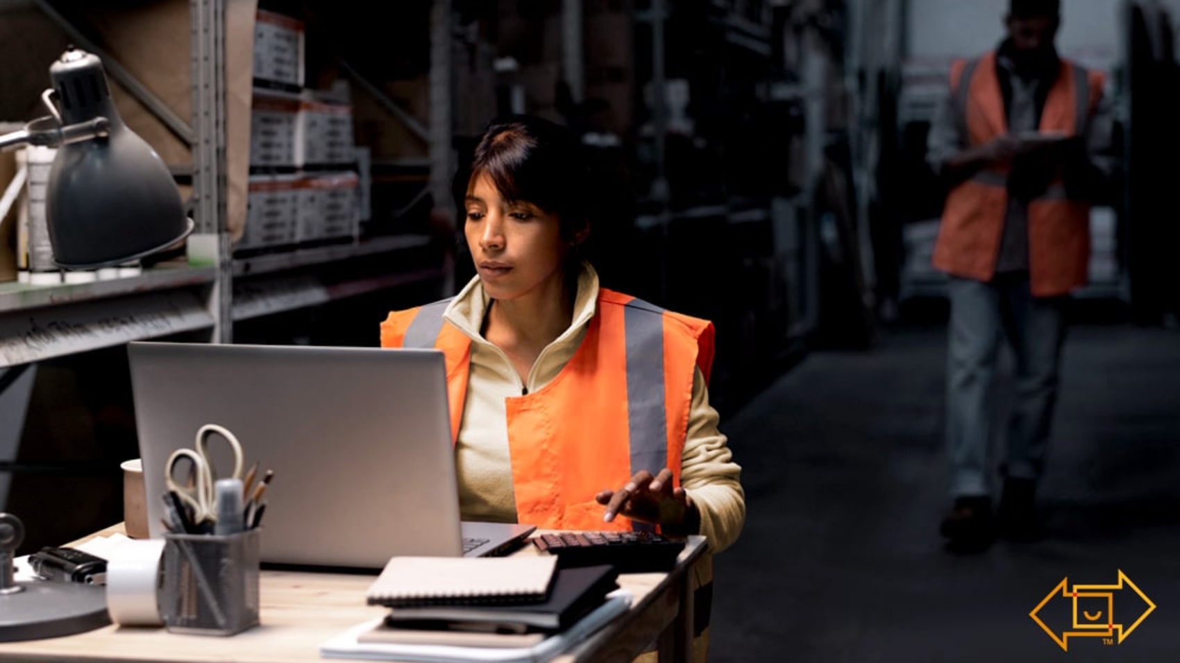 warehouse worker with a calculator and laptop