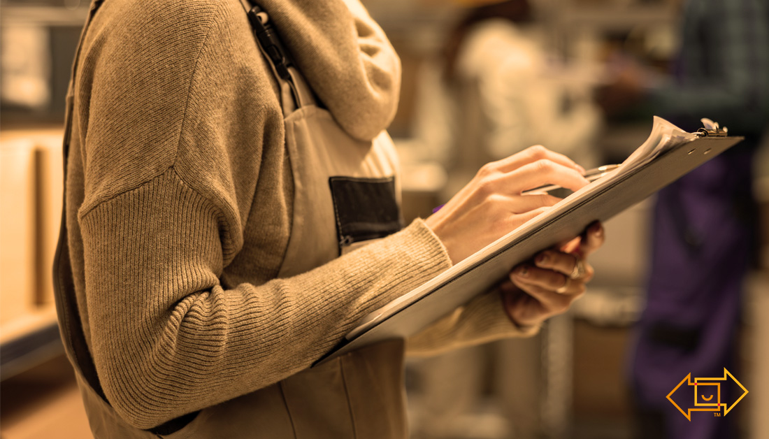 female warehouse worker with clipboard for labor management