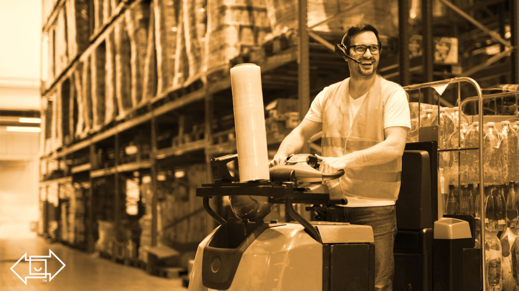 warehouse employee on a machine smiling