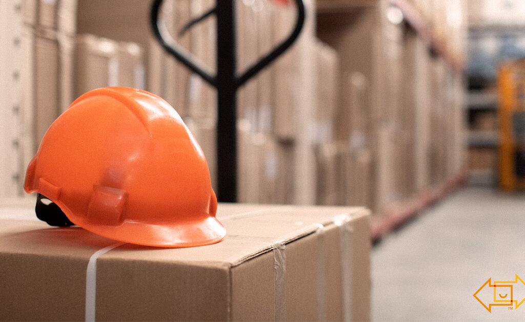 safety helmet on top of a box in a warehouse