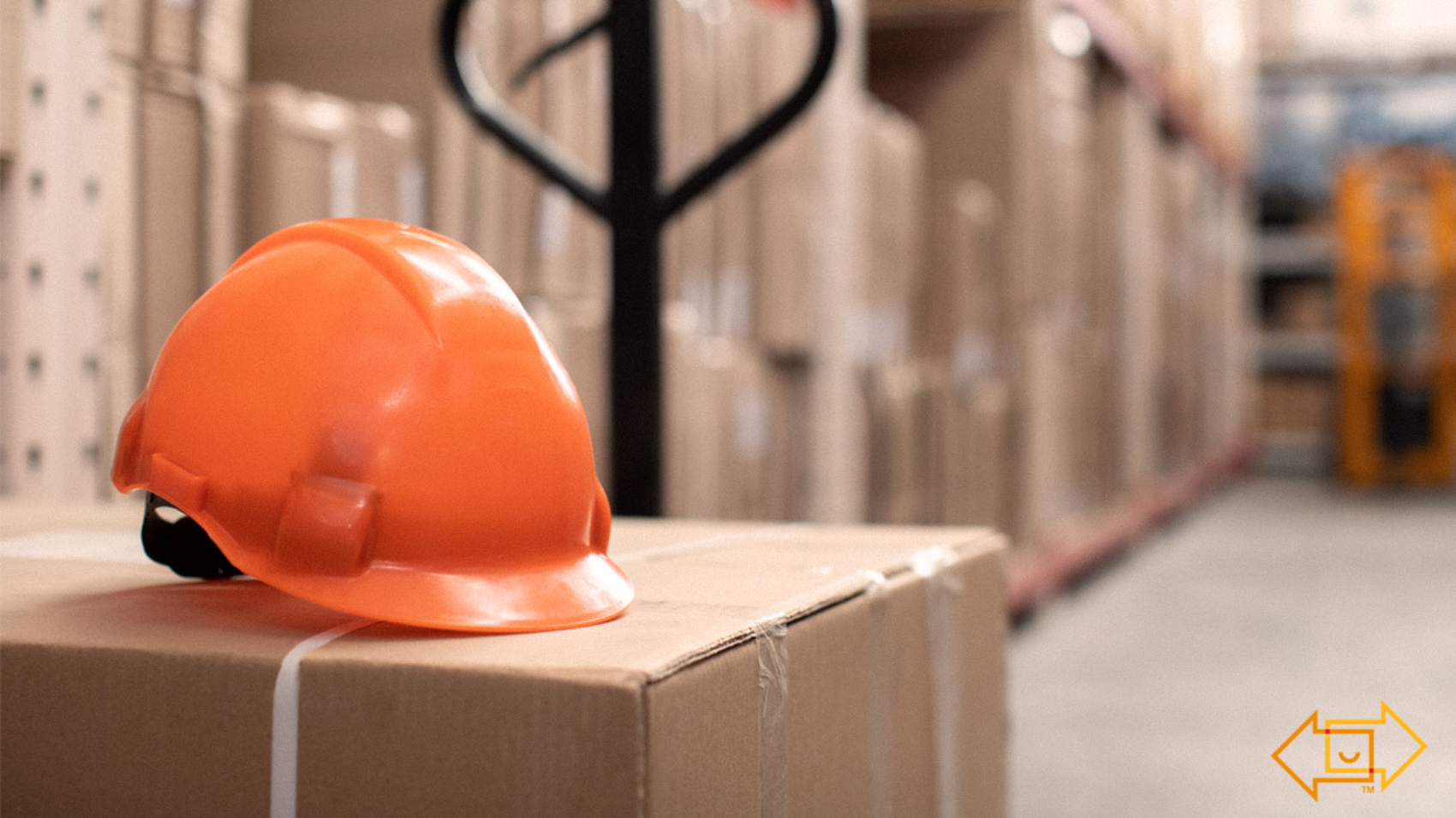 safety helmet on top of a box in a warehouse