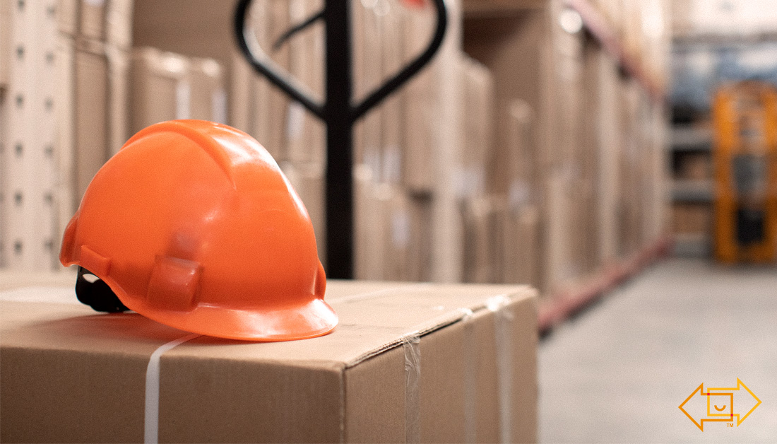 safety helmet on top of a box in a warehouse