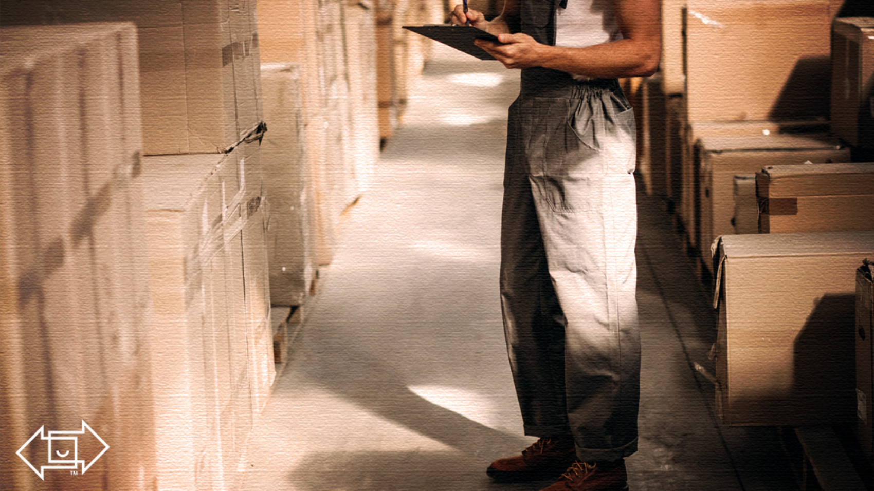 warehouse worker looking at a clipboard evaluating a client experience survey